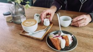 A relaxing café scene with a cup of coffee and a slice of cake, perfect for lifestyle themes.